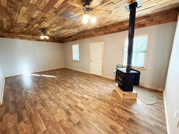 a kitchen with wooden floors and wooden cabinets