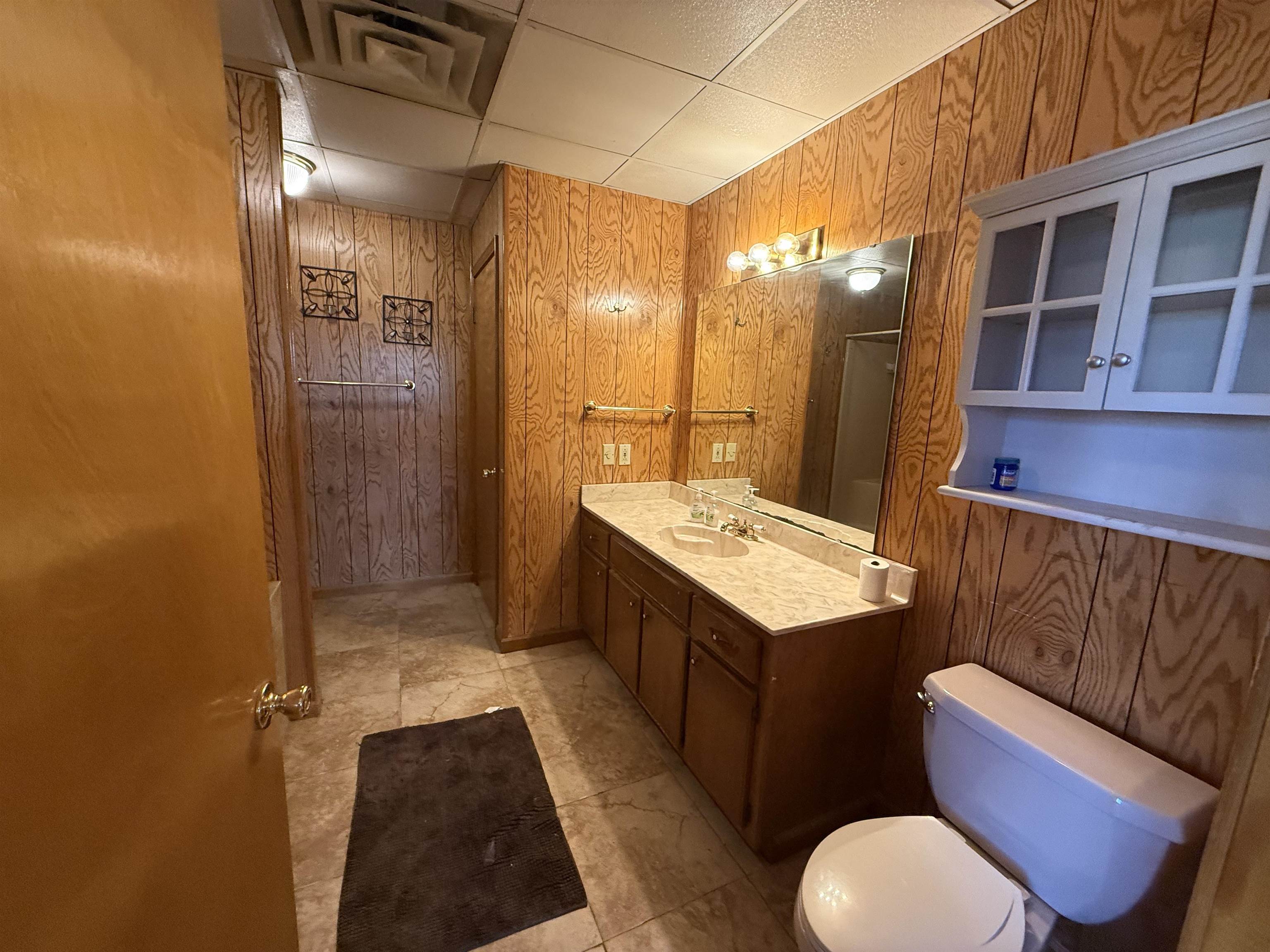 2142 Highway 70 Mason, TN 38049 - Photo 17 of 36 Bathroom with wooden walls, vanity, and a drop ceiling