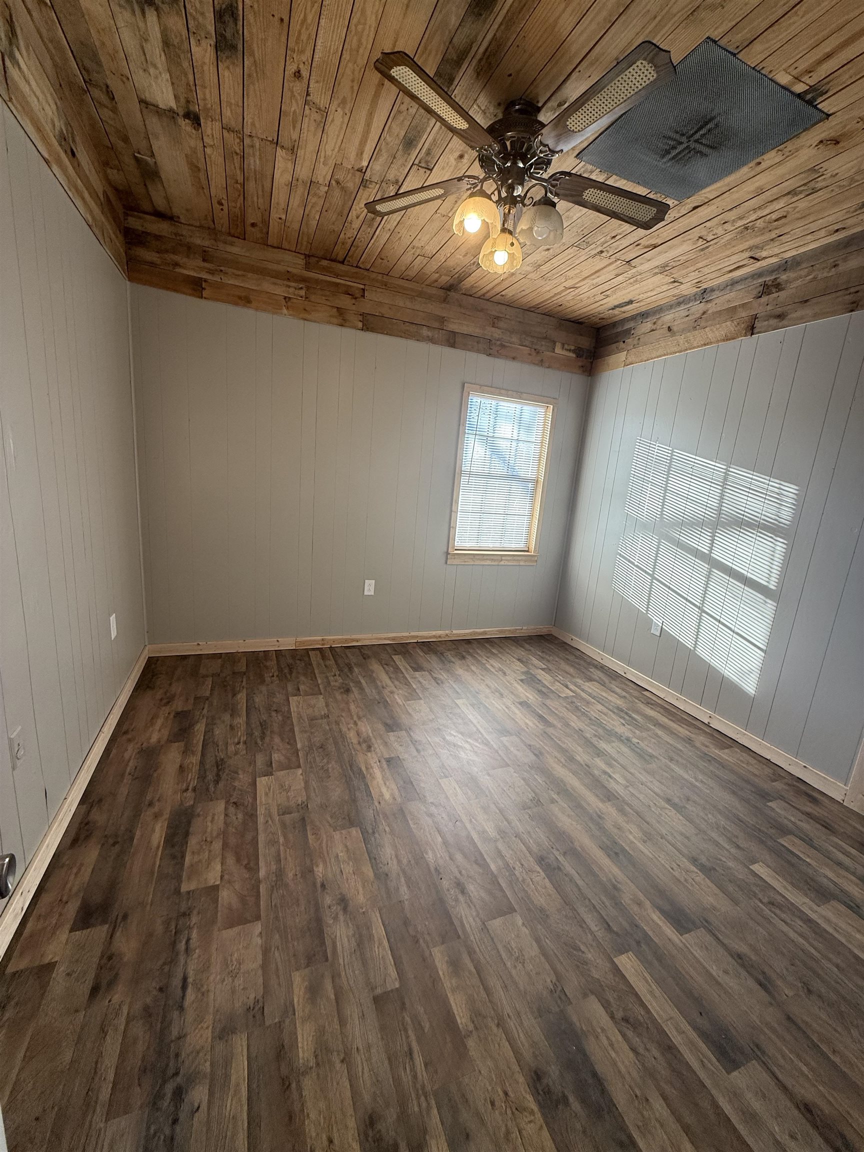 2142 Highway 70 Mason, TN 38049 - Photo 21 of 36 Bedroom with wooden ceiling, dark wood-style floors, ceiling fan, and wooden walls
