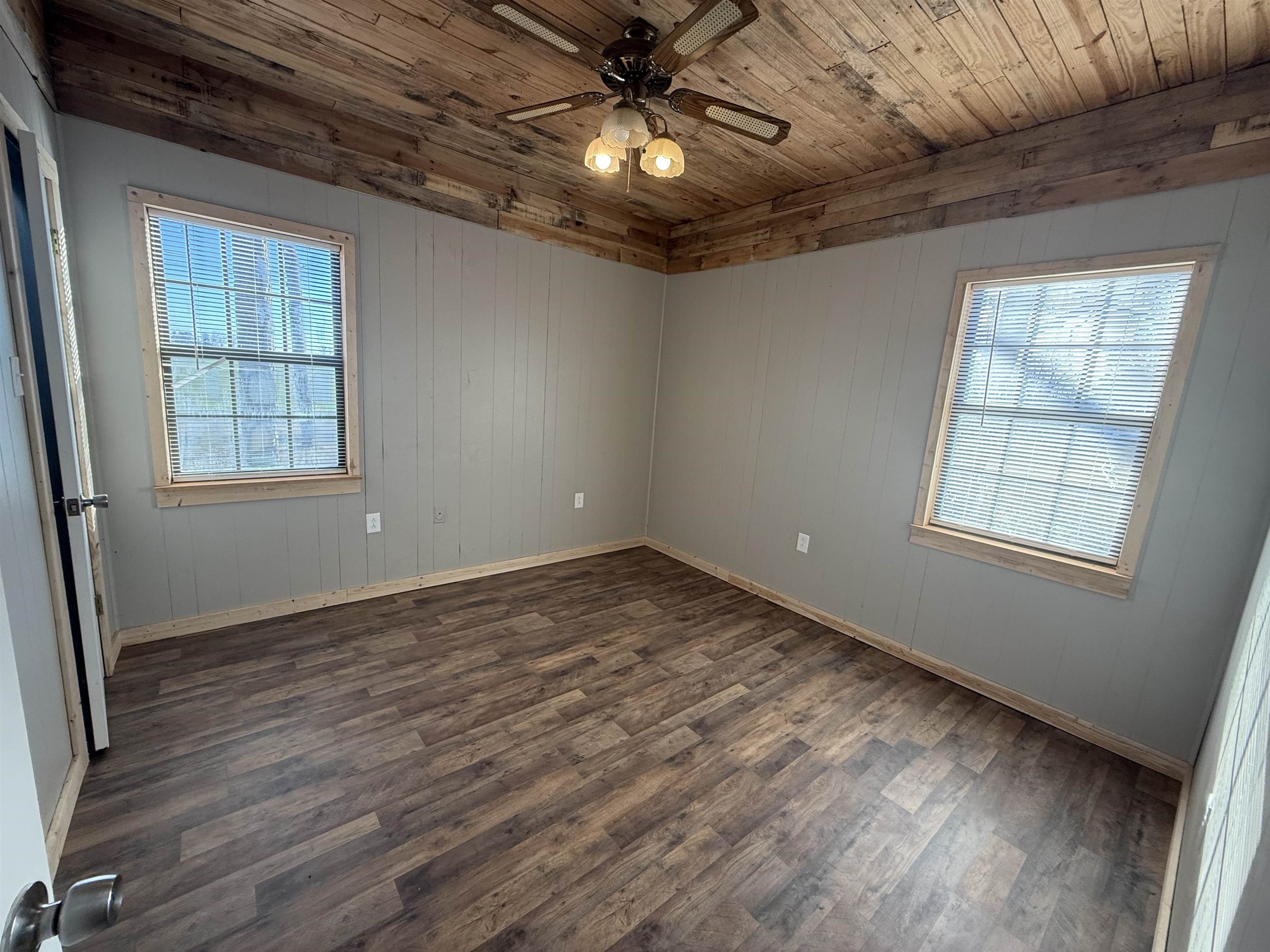 2142 Highway 70 Mason, TN 38049 - Photo 23 of 36 Bedroom with ceiling fan, dark wood-style flooring, wood ceiling, and wooden walls