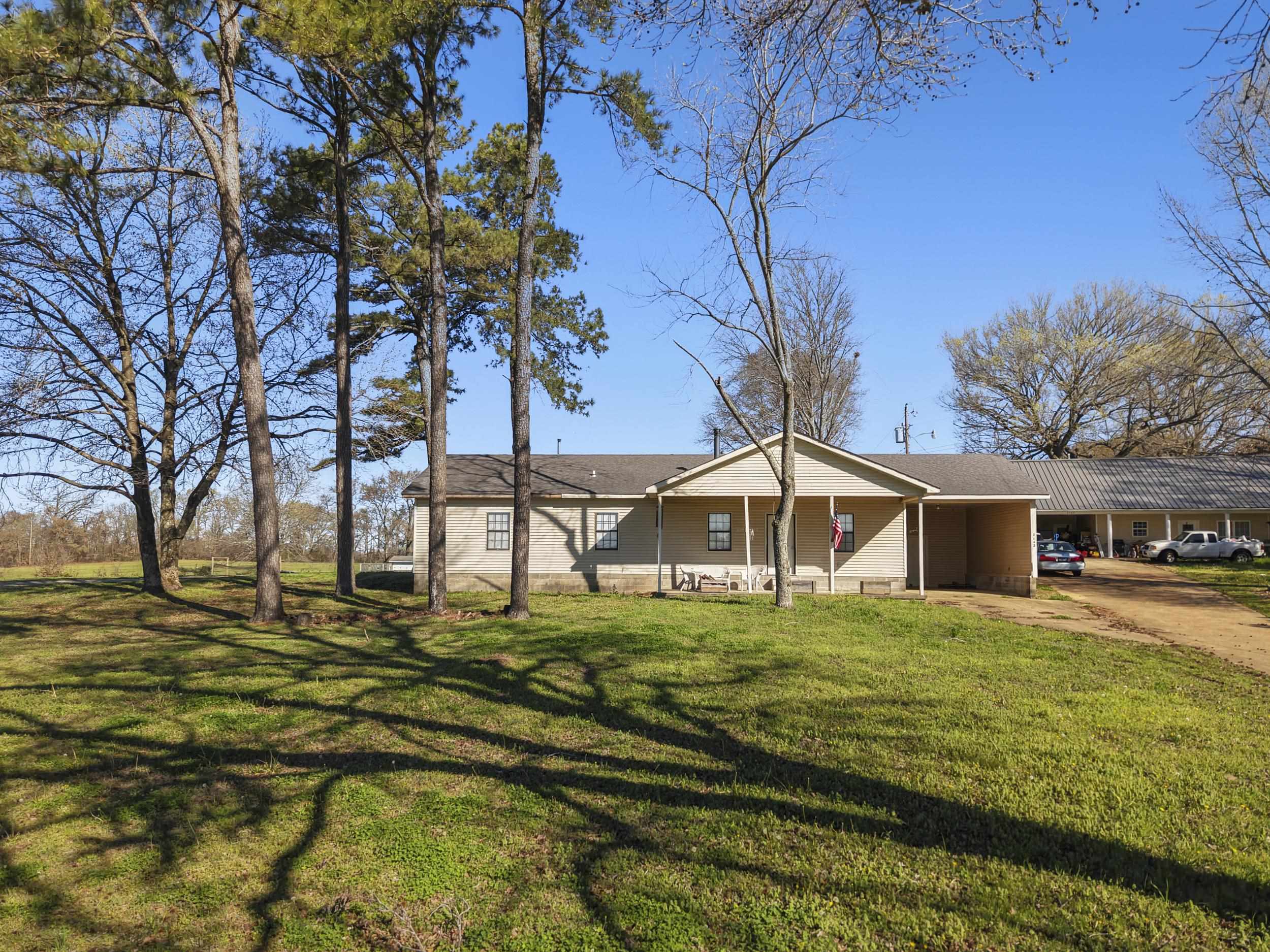 2142 Highway 70 Mason, TN 38049 - Photo 7 of 38 Ranch-style home featuring a carport, driveway, and a front lawn