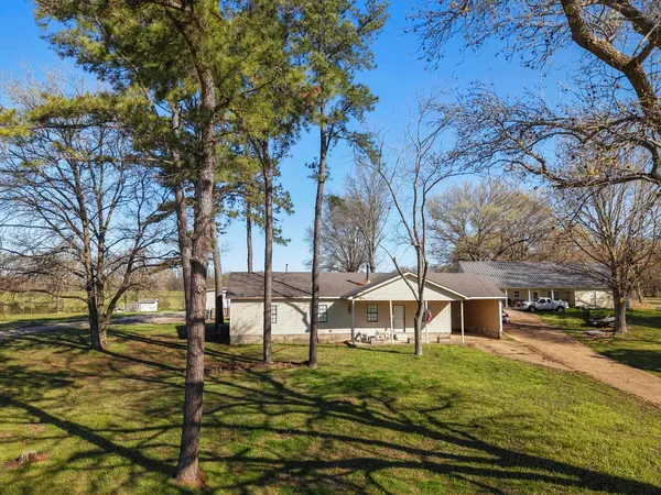 a living room with furniture a fireplace and a chandelier