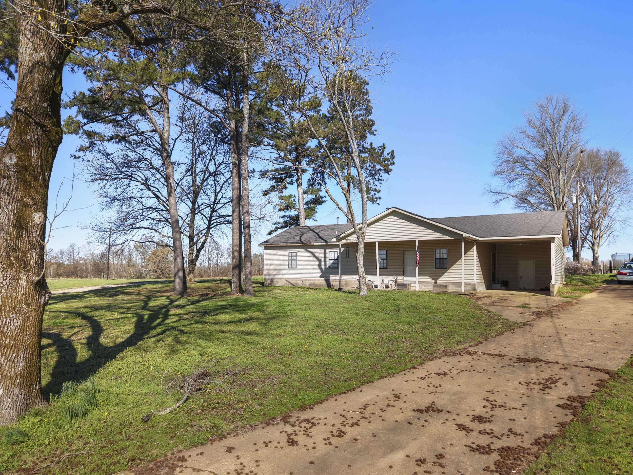 2142 Highway 70 Mason, TN 38049 - Photo 9 of 38 a front view of a house with a yard and garage