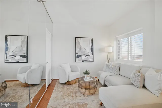 a living room with furniture wooden floor and a table
