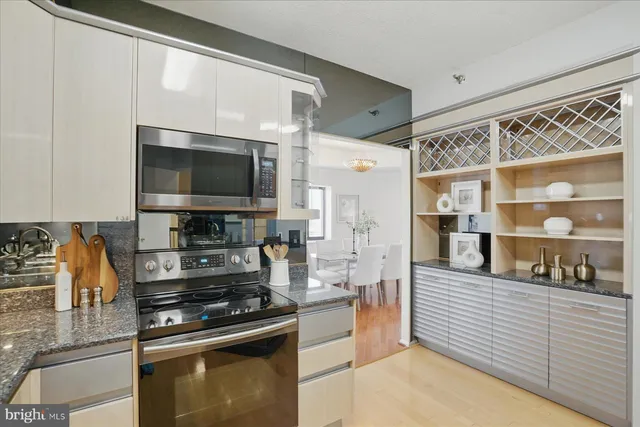 a kitchen with stainless steel appliances granite countertop a sink stove and cabinets