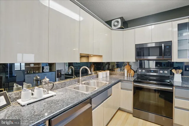 a kitchen with cabinets and stainless steel appliances