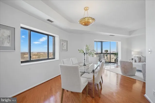 a view of a dining room with furniture window and wooden floor