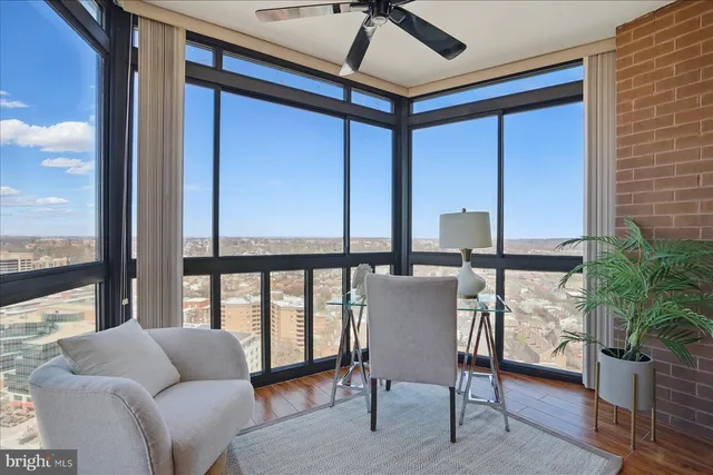 a living room with furniture and a floor to ceiling window