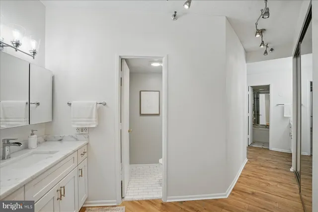 a view of a hallway with wooden floor