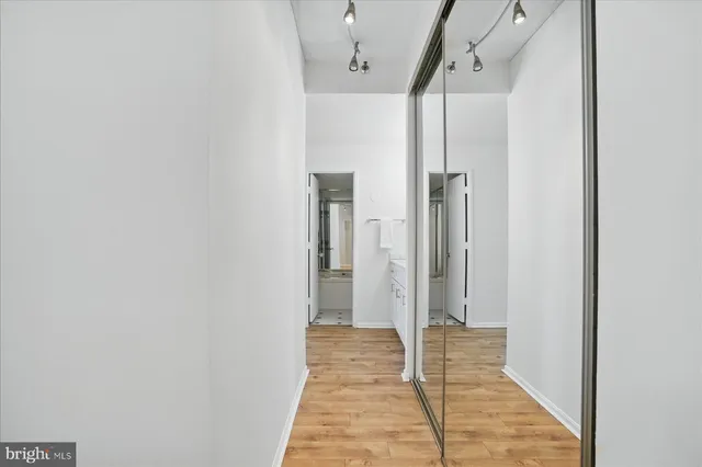 a view of staircase with wooden floor and white walls