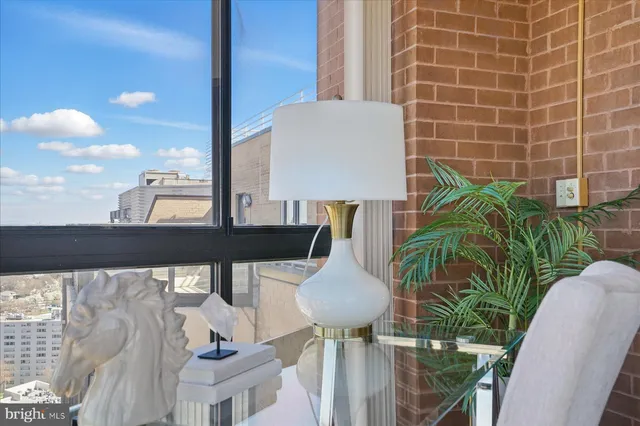a view of balcony with potted plants and outdoor seating
