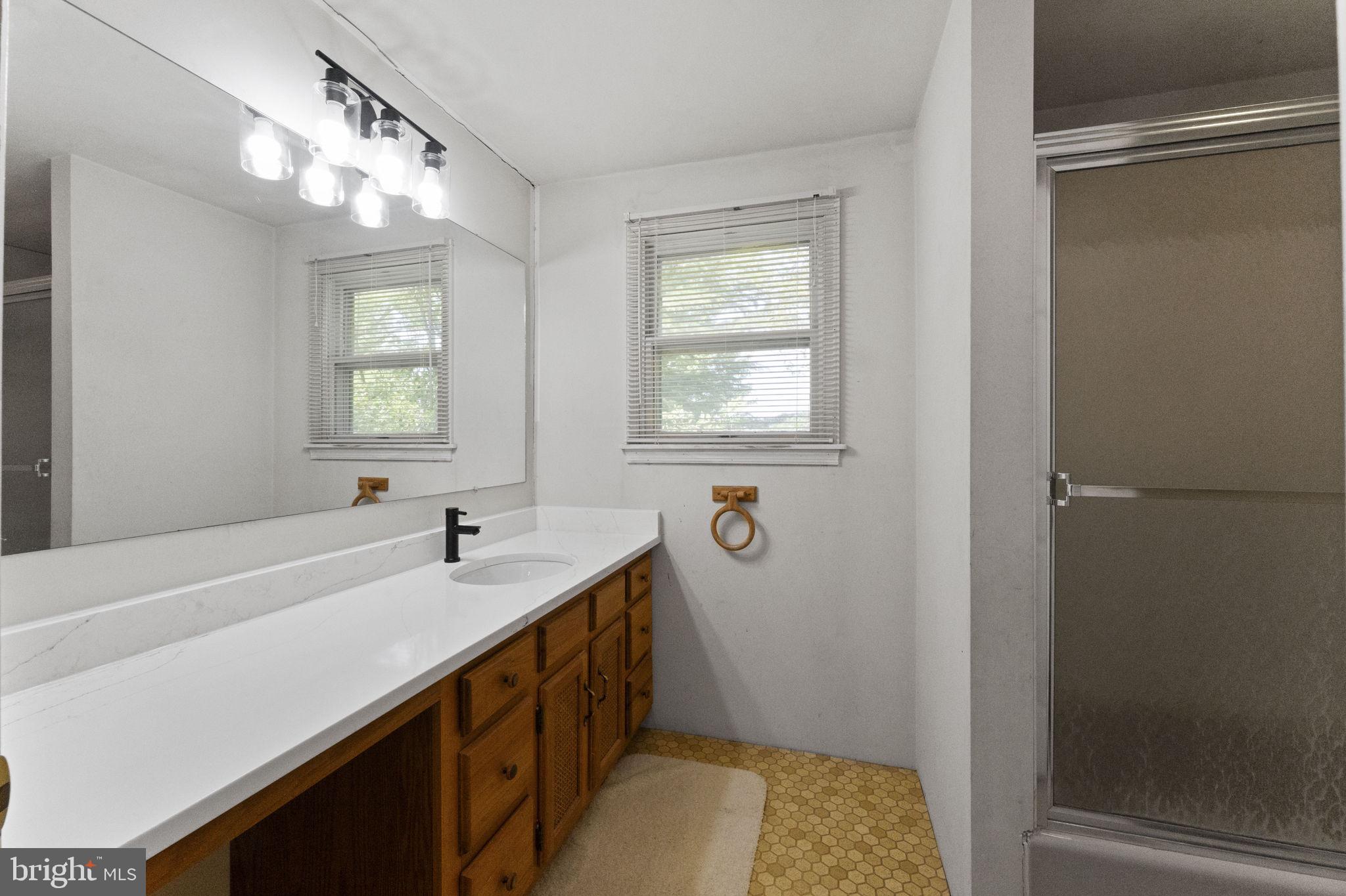 215 Bethel Road Spring City, PA 19475 - Photo 19 of 29 a bathroom with a sink and a mirror