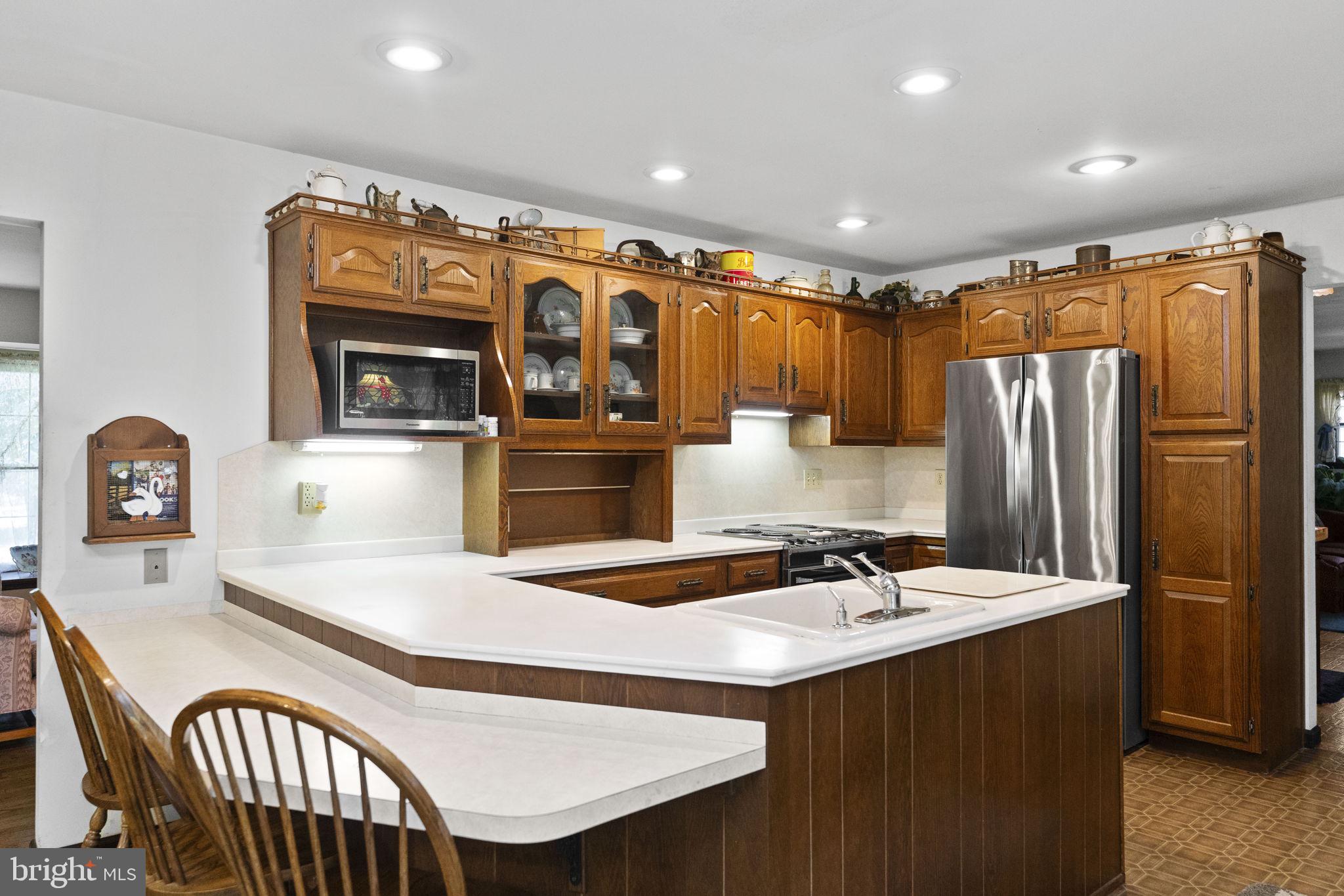 215 Bethel Road Spring City, PA 19475 - Photo 7 of 29 a kitchen with stainless steel appliances granite countertop a sink refrigerator and cabinets