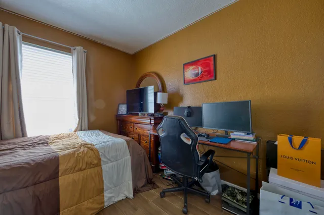 a bedroom with a bed and a desk