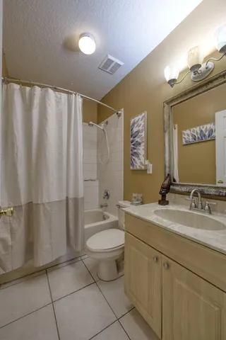 a bathroom with a double vanity sink toilet and mirror