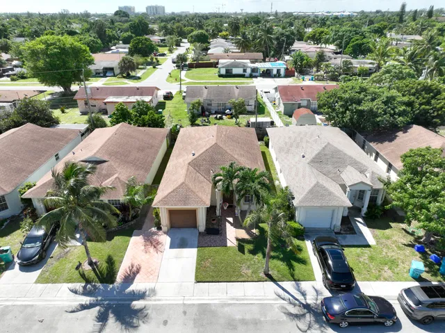 an aerial view of a house with garden space and street view