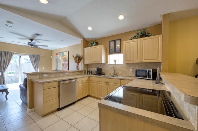 a kitchen that has a sink and a stove in it