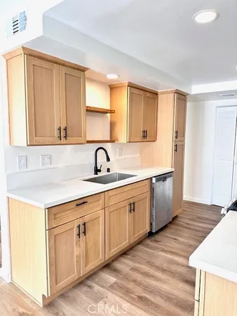 a kitchen with sink and cabinets
