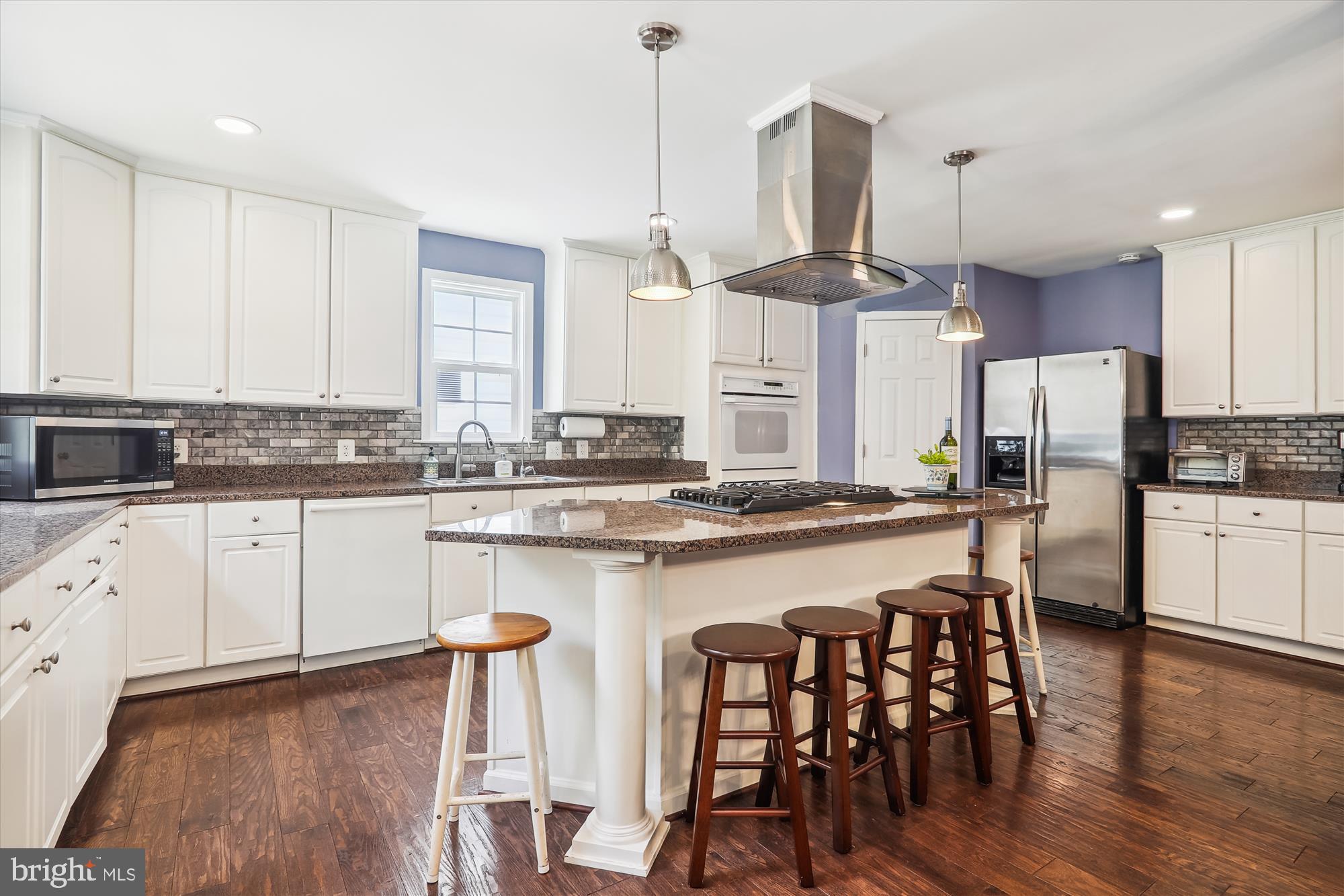 9805 Five Oaks Road Fairfax, VA 22031 - Photo 17 of 70 a kitchen with stainless steel appliances a dining table chairs sink and cabinets
