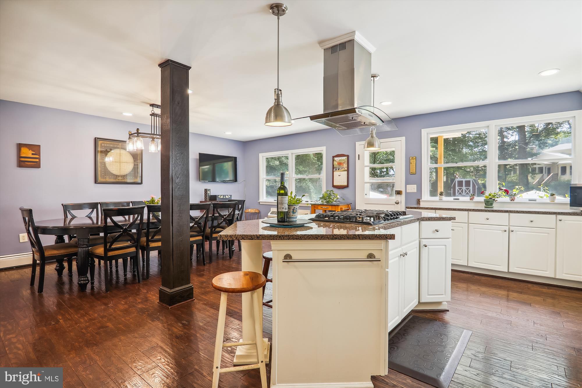 9805 Five Oaks Road Fairfax, VA 22031 - Photo 19 of 70 a open kitchen with stainless steel appliances granite countertop a stove top oven a sink a dining table and chairs with wooden floor