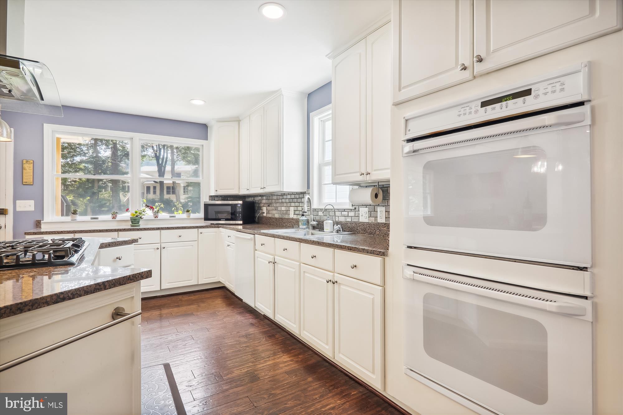 9805 Five Oaks Road Fairfax, VA 22031 - Photo 20 of 70 a kitchen with granite countertop white cabinets and white appliances