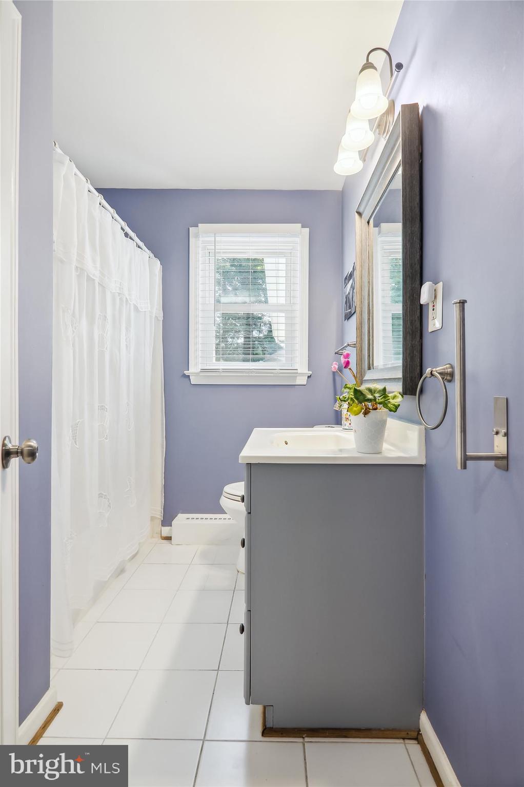 9805 Five Oaks Road Fairfax, VA 22031 - Photo 25 of 70 a bathroom with a sink a bathtub and a window