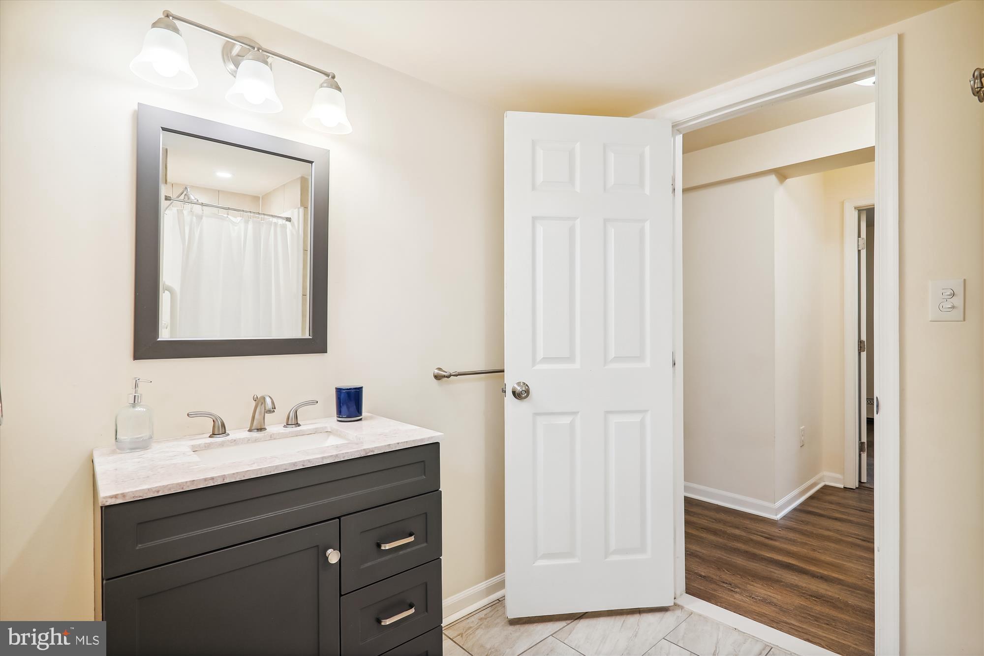 9805 Five Oaks Road Fairfax, VA 22031 - Photo 41 of 70 a bathroom with a sink a light fixture and a mirror