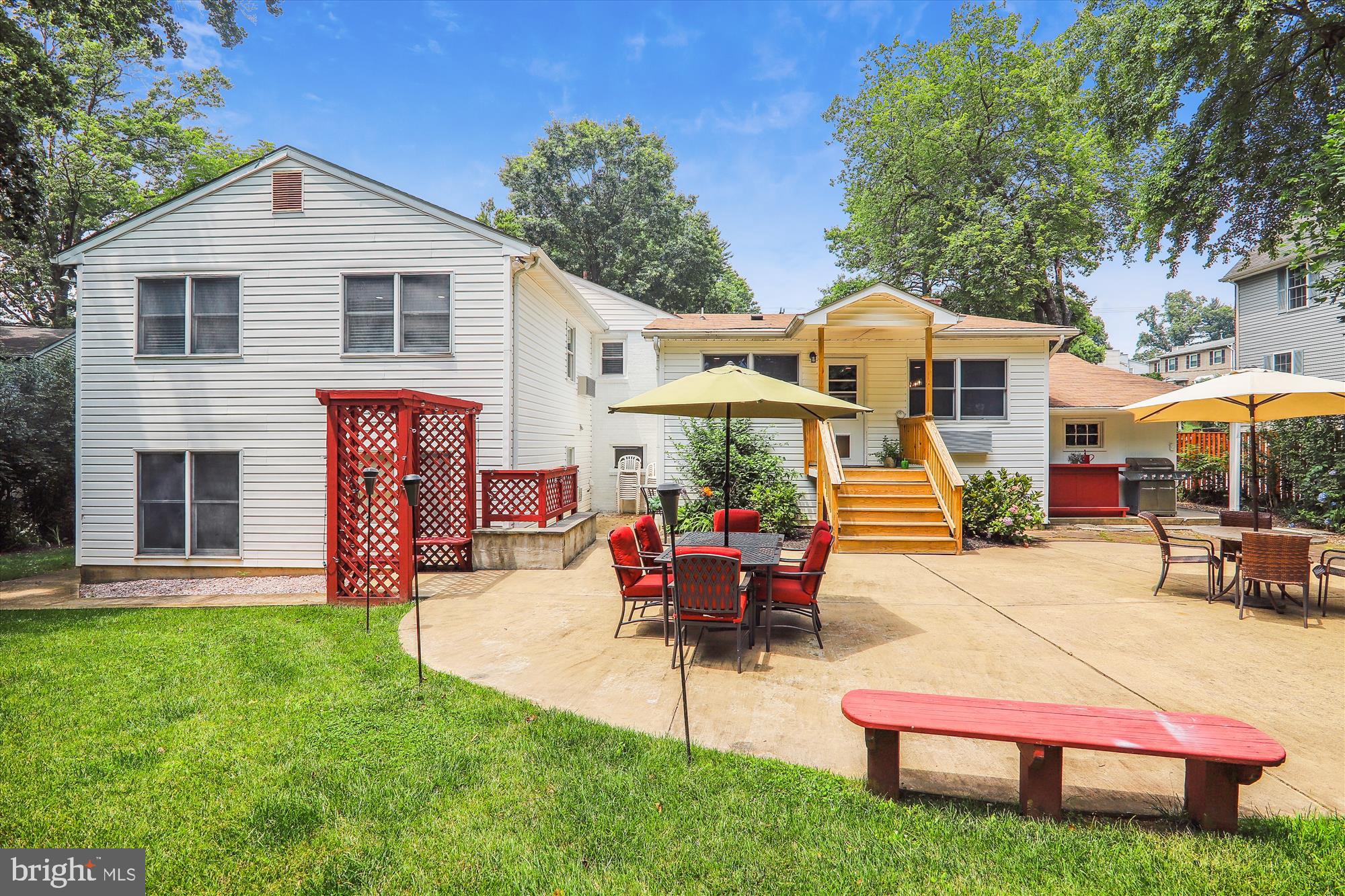 9805 Five Oaks Road Fairfax, VA 22031 - Photo 52 of 70 a patio with a table and chairs under an umbrella