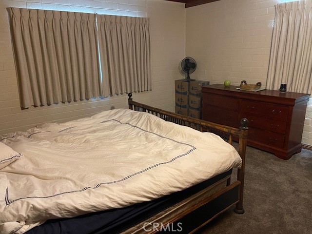 13127 East Ave W 11 Pearblossom, CA 93553 - Photo 17 of 23 a bed sitting in a bedroom with a mirror