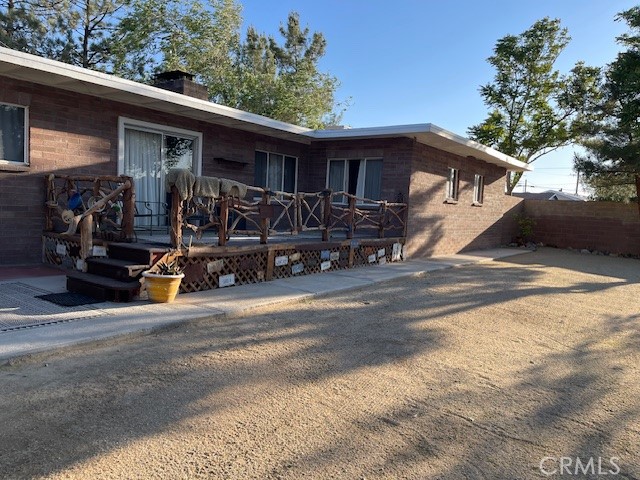 13127 East Ave W 11 Pearblossom, CA 93553 - Photo 20 of 23 a view of a patio with table and chairs and wooden fence
