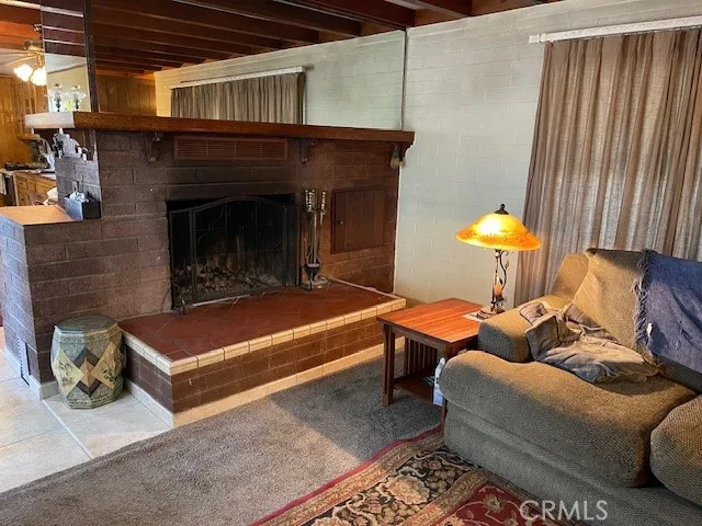 a living room with furniture rug and wooden floor