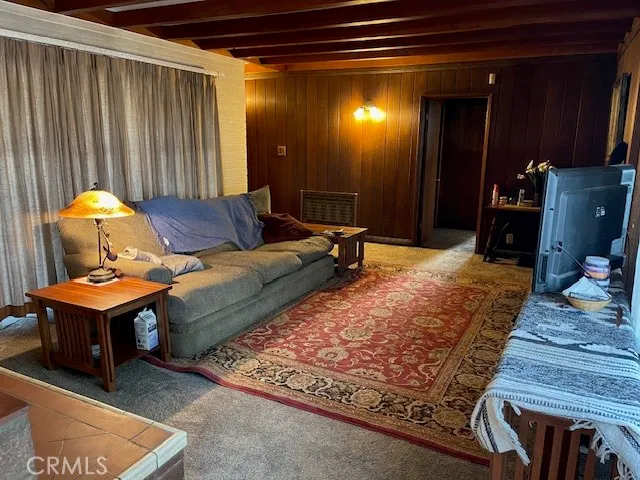 a dining room with furniture and a rug