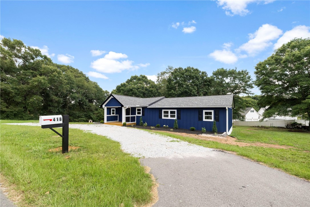 418 Old River Road Pelzer, SC 29669 - Photo 2 of 29 A newly constructed residence features an inviting front porch and a long gravel driveway.