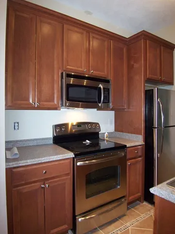 a kitchen with a stove microwave and sink