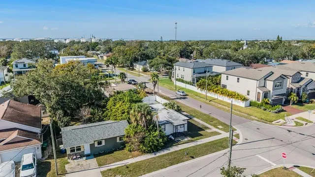 an aerial view of residential houses with outdoor space and street view