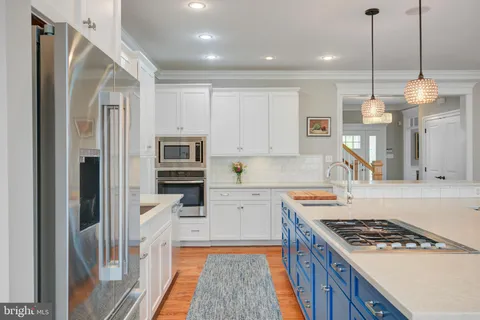 a view of a dining room with furniture large windows and wooden floor