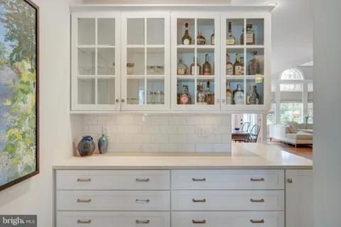 a living room with furniture a large window and a table