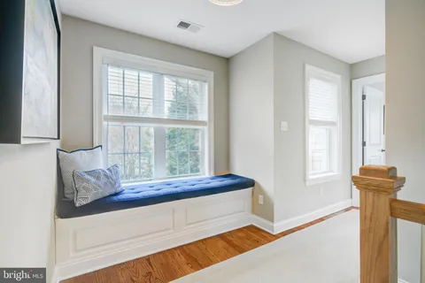 a bedroom with a large bed and a large window