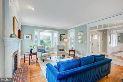 a dining room with furniture a chandelier and wooden floor