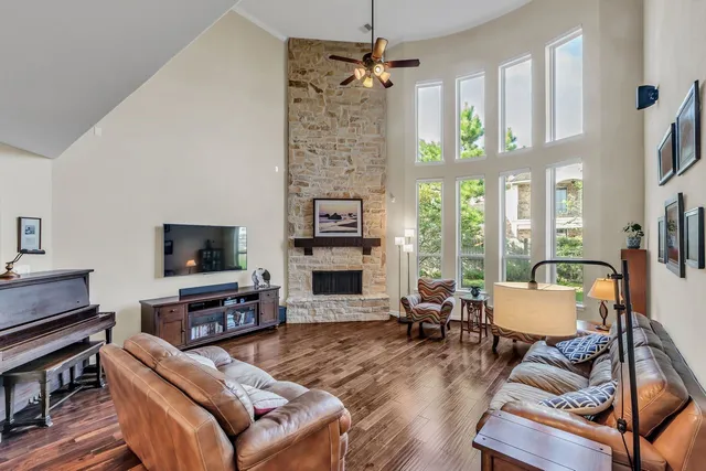 a living room with furniture a fireplace and a flat screen tv