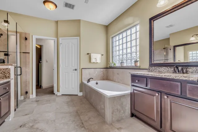 a large kitchen with kitchen island granite countertop a sink and refrigerator