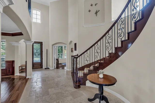 a view of entryway and hall with wooden floor