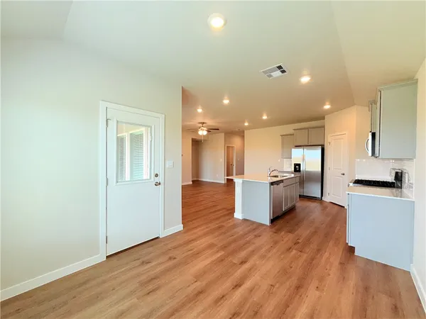 a large kitchen with a lot of counter top space and stainless steel appliances