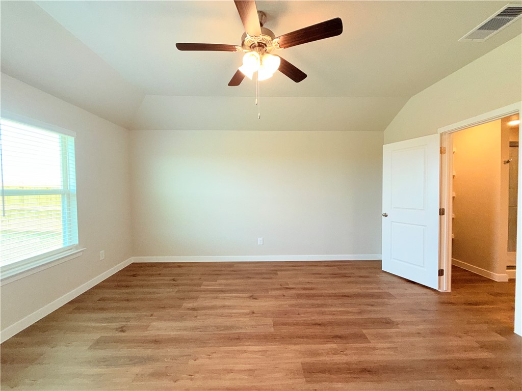 1116 Zeus Portland, TX 78374 - Photo 12 of 39 an empty room with wooden floor fan and windows