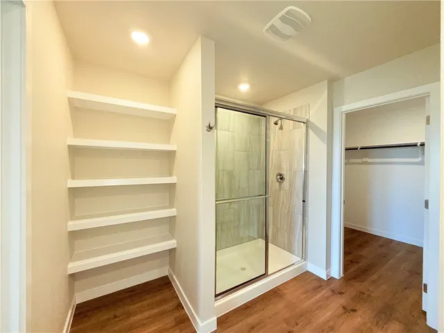 a bathroom with a glass shower door