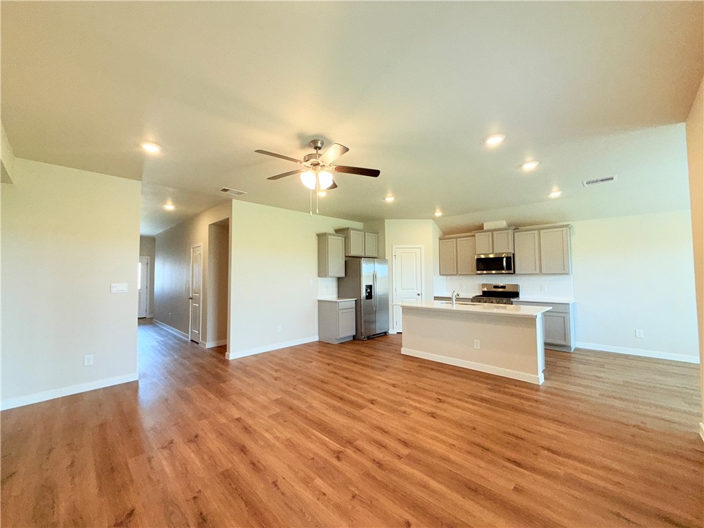 1116 Zeus Portland, TX 78374 - Photo 2 of 39 a view of kitchen with refrigerator microwave and wooden floor