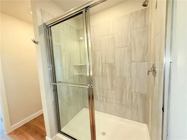 a bathroom with a glass shower door