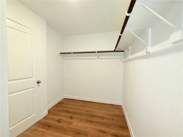 a view of a room with wooden floor and white walls