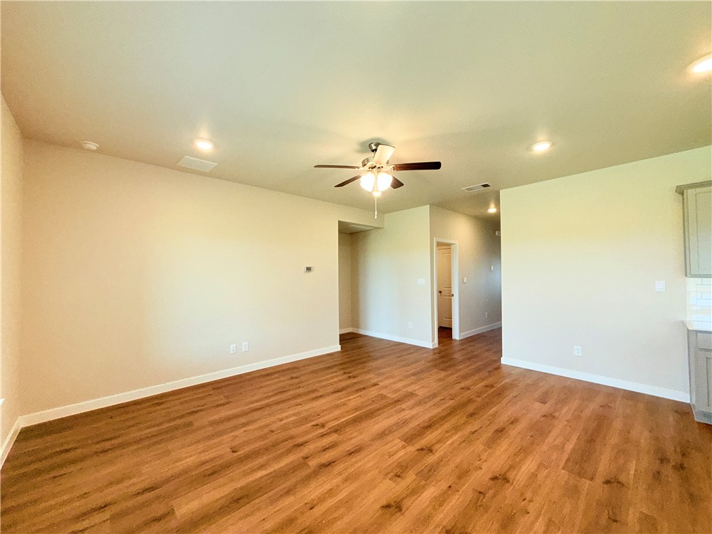 1116 Zeus Portland, TX 78374 - Photo 3 of 39 a view of an empty room with wooden floor and a ceiling fan
