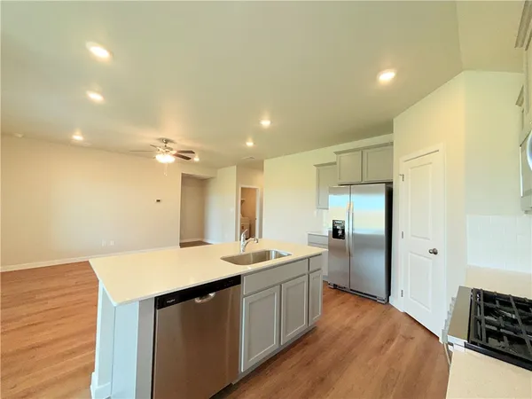 a kitchen with a sink appliances and cabinets